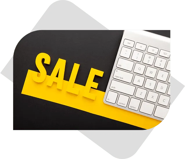 A bold "Sale" text in vibrant yellow on a sleek black surface next to a keyboard, showcasing dynamic graphic design.