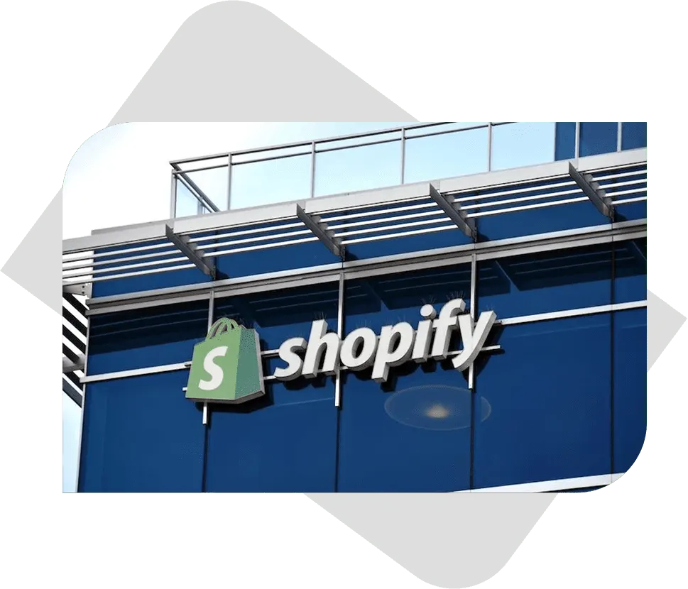 Close-up view of the Shopify logo on a modern office building