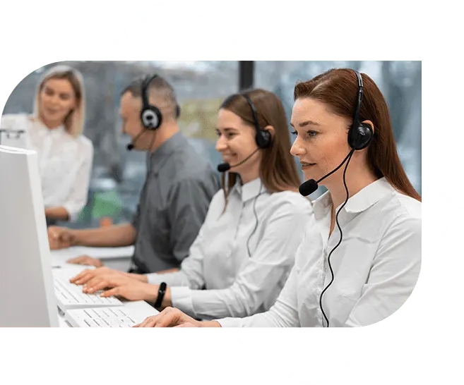 Three female customer service representatives at Velocity Sellers sitting in front of computers, actively managing customer queries, including one male team member.